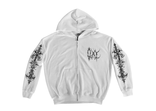 White hoodie with black floral designs on sleeves against a gray background
