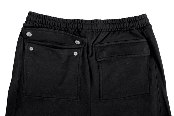 Black pants with button details on a light gray background