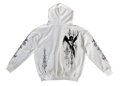 White hoodie with black graphic designs on a gray surface