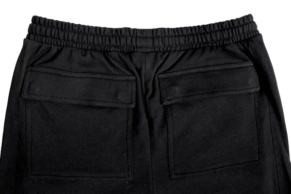 Black pants with two back pockets on a light gray background