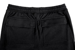 Black pants with two back pockets on a light gray background