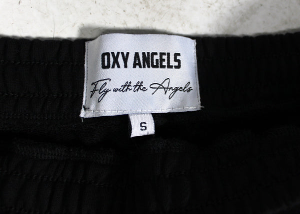 Close-up of an 'OXY ANGELS' label on a garment with a white background.