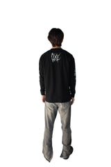 Person wearing a black long-sleeve shirt with a logo on the back, standing against a white background.