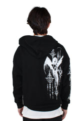 Person wearing a black hoodie with a white graphic design on the back against a plain background