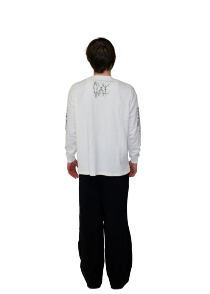 Person wearing a white long-sleeve shirt with text on the back against a plain background