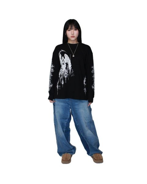 Person wearing a black long-sleeve shirt with white graphic design and blue jeans on a white background