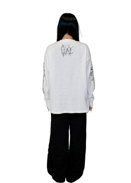 Person wearing a white long-sleeve shirt with black text and graphics on the back, standing against a plain white background.