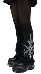 Black knee-high boots with white embroidery on a white background