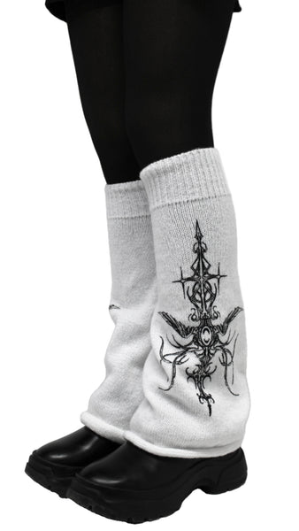White socks with black tattoo design worn with black shoes on a light gray background