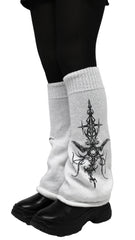 White socks with black tattoo design worn with black shoes on a light gray background