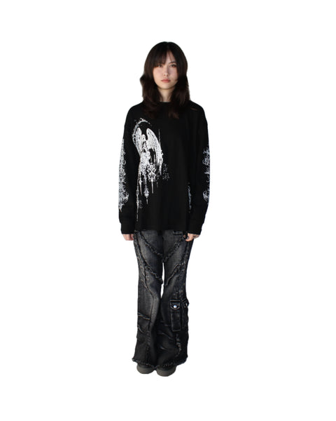 Person wearing a black sweater with a white design on a white background