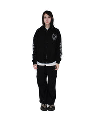 Person wearing a black jacket with white designs on a white background